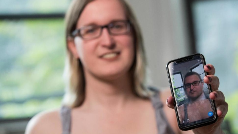 In this Wednesday, May 15, 2019, photo, Bailey Coffman shows her photo as a man in the Snapchat app during an interview in New York. Snapchat's new photo filter that allows users to change into a man or woman with the tap of a finger isn’t necessarily fun and games for transgender people. (AP Photo/Mary Altaffer)