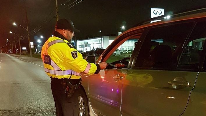 An officer with the Windsor Police Service Traffic Unit speaks with a driver at a R.I.D.E. program in east Windsor on Saturday May 18, 2019. 
(Photo: Windsor Police Service)