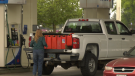 A Canadian woman fills several jerrycans full of cheap U.S. fuel before coming back over the border. 