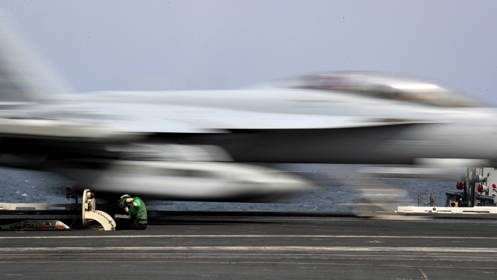 An F-18 takes off from the USS Abraham Lincoln