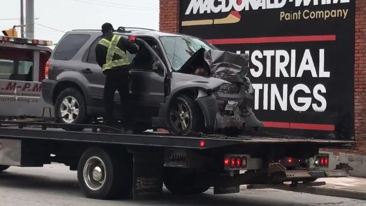 An SUV is removed from the road after a crash on Walker Road in Windsor, Ont., on Wednesday, May 29, 2019. (Michelle Maluske / CTV Windsor)
