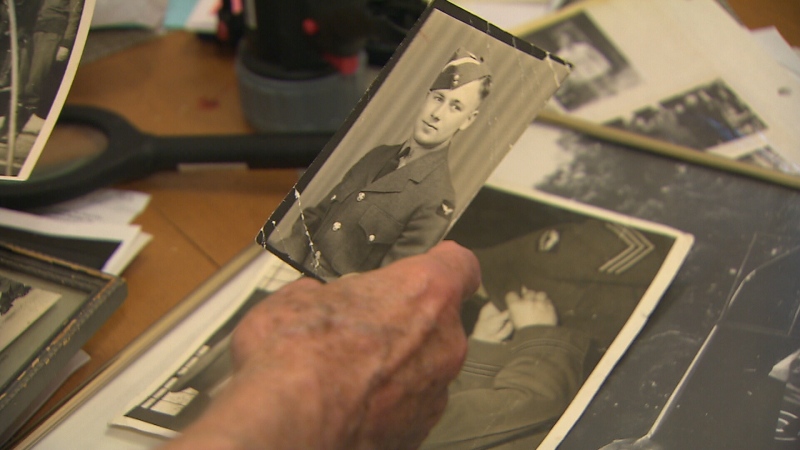 Jack Miller looks through photographs from his time with the Royal Canadian Air Force.
