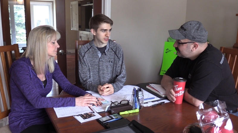 Brandan Barnett, center, along with his parents Lisa and Dan, are seen at their home in London, Ont. (Celine Moreau / CTV London)