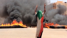 A protester wearing a Sudanese flag