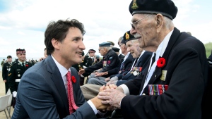 Prime Minister Justin Trudeau shakes hands with Veteran of the Second World War Bill Anderson as they visit Juno Beach following the D-Day 75th Anniversary Canadian National Commemorative Ceremony at Juno Beach in Courseulles-Sur-Mer, France on Thursday, June 6, 2019. THE CANADIAN PRESS/Sean Kilpatrick