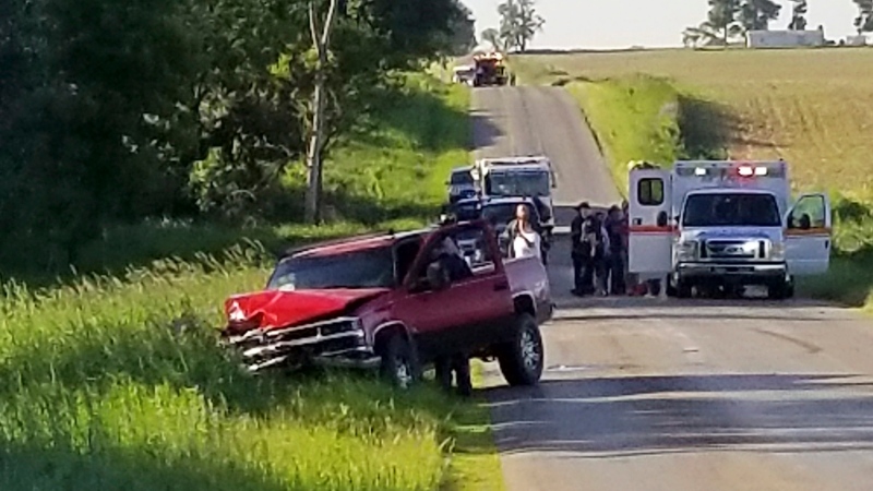A damaged truck sits on the side of the road after an accident involving a horse-drawn carriage on Friday, June 7, 2019 in California Township, Mich. Michigan State Police said the pick up truck was headed southbound when the driver rear ended an Amish, horse-drawn carriage. Two adults and five children were ejected from the carriage. (Don Reid/The Daily Reporter via AP)