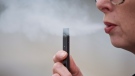 A woman exhales a puff of vapor from a Juul pen in Vancouver, Wash., Tuesday, April 16, 2019. (AP Photo/Craig Mitchelldyer)