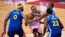 Toronto Raptors forward Kawhi Leonard (2) draws a foul as he drives to the net against Golden State Warriors centre DeMarcus Cousins (0), forward Draymond Green (23) and forward Andre Iguodala (9) during second half basketball action in Game 5 of the NBA Finals in Toronto on Monday, June 10, 2019. THE CANADIAN PRESS/Chris Young