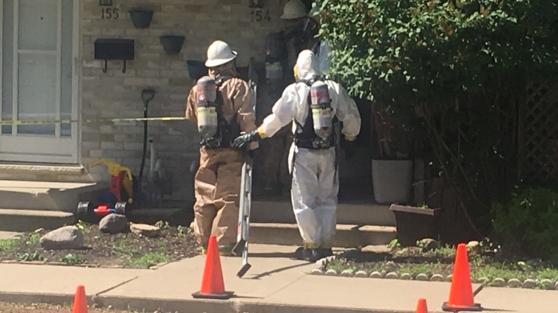 Police and firefighters wearing hazardous materials suits work at an alleged drug lab in London, Ont. on Wednesday, June 12, 2019. (Gerry Dewan / CTV London)