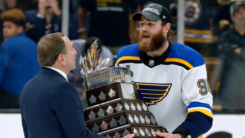 NHL Commissioner Gary Bettman presentes St. Louis Blues' Ryan O'Reilly with the Conn Smythe trophy after the Blues' win over the Boston Bruins in Game 7 of the NHL hockey Stanley Cup Final, Wednesday, June 12, 2019, in Boston. (AP Photo/Michael Dwyer)
