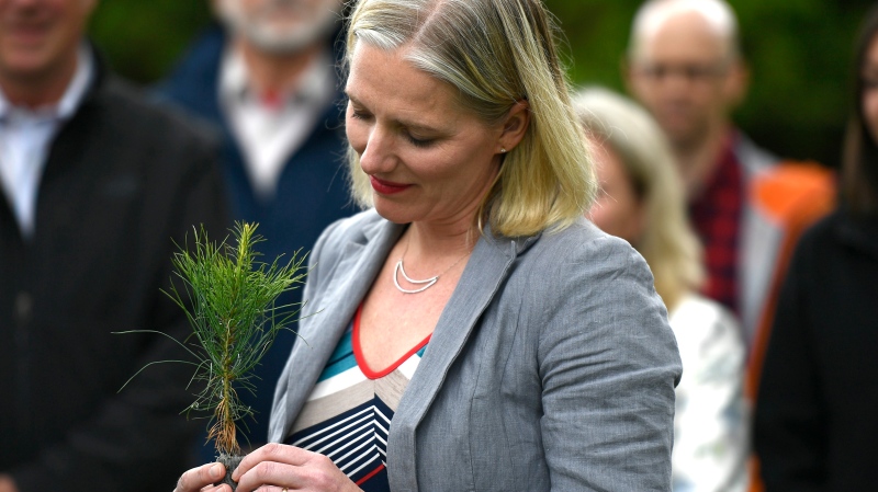 Minister of Environment and Climate Change Catherine McKenna holds a sapling during a funding announcement to support Forests Ontario in planting 50 million trees by 2025, on World Environment Day at the Dominion Arboretum in Ottawa on Wednesday, June 5, 2019. THE CANADIAN PRESS/Justin Tang
