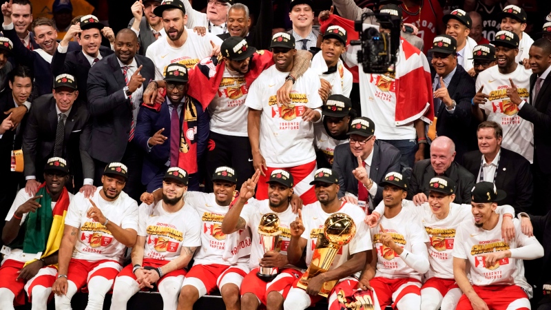 Toronto Raptors players and coaches celebrate after the Raptors defeated the Golden State Warriors in Game 6 of basketball's NBA Finals in Oakland, Calif., Thursday, June 13, 2019. (AP Photo/Tony Avelar)