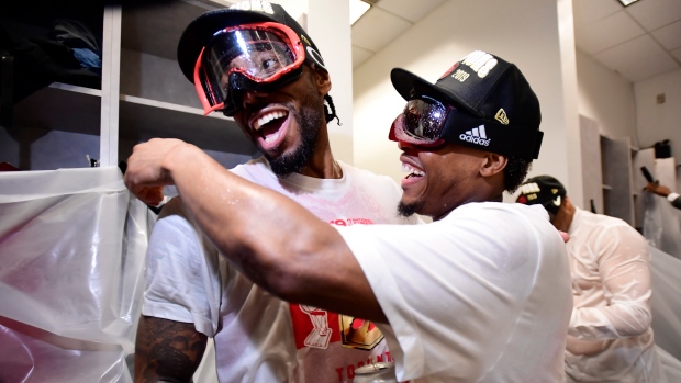 Toronto Raptors forward Kawhi Leonard, left, and teammateKyle Lowry celebrate defeating the Golden State Warriors and winning the Larry O'Brien NBA Championship Trophy after Game 6 basketball action in Oakland, Calif. on Thursday, June 13, 2019. THE CANADIAN PRESS/Frank Gunn