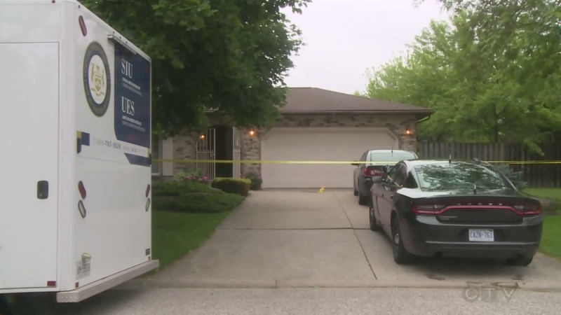 An SUI vehicle and crime-scene tape are seen at the house of a fatal shooting in Tecumseh on Saturday, June 15, 2019.