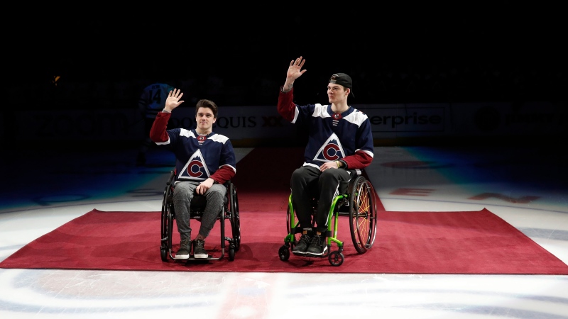 FILE - In this Saturday, Nov. 24, 2018, file photo, Ryan Straschnitzki, left, and Jacob Wassermann, victims of the Humboldt, Saskatchewan bus crash in 2017, are introduced in the first period of an NHL hockey game, in Denver. (AP Photo/David Zalubowski, File)
