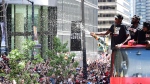 Toronto Raptors forward Pascal Siakam sprays the crowd with champagne as he celebrates during the 2019 Toronto Raptors Championship parade in Toronto on Monday, June 17, 2019. THE CANADIAN PRESS/Frank Gunn