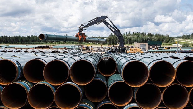 Pipe for the Trans Mountain pipeline is unloaded in Edson, Alta. on Tuesday June 18, 2019. THE CANADIAN PRESS / Jason Franson