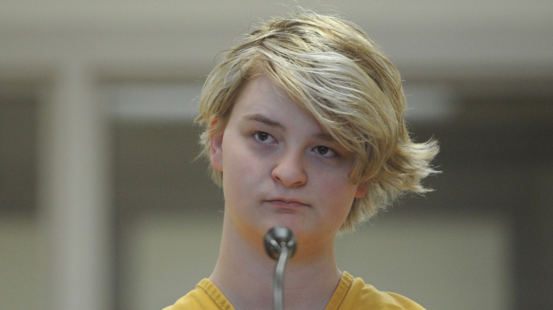In this Sunday, June 9, 2019 photo, Denali Brehmer, 18, stands at her arraignment in the Anchorage Correctional Center in Anchorage, Alaska. Brehmer has been charged with first-degree murder in the death of Cynthia Hoffman. . (Bill Roth/Anchorage Daily News via AP)