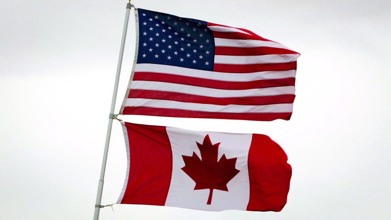 U.S. and Canadian flags fly in Point Roberts, Wash., on Tuesday, March 13, 2012. THE CANADIAN PRESS/Darryl Dyck