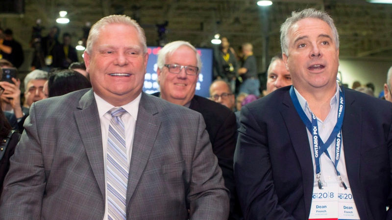 Ontario Premier Doug Ford, centre, sits alongside then Chief of Staff Dean French at the Ontario PC Convention in Toronto on Saturday, November 17, 2018. (THE CANADIAN PRESS/Chris Young)