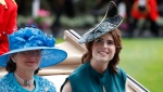 Princess Eugenie, right, looks on as she arrives on the third day of the annual Royal Ascot horse race meeting, which is traditionally known as Ladies Day, in Ascot, England, Thursday June 20, 2019. (AP Photo/Alastair Grant)
