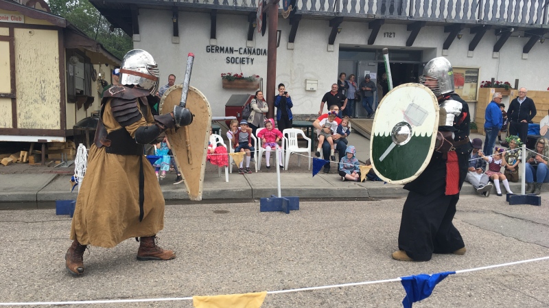 Two members of the Shire of Sigelhundas prepare for battle outside the Regina German Club at Saturday’s summer solstice celebration. (Cole Davenport/CTV Regina)