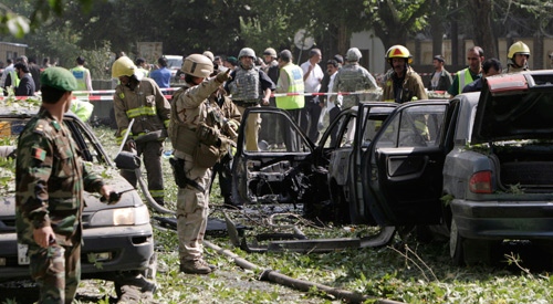 Destroyed vehicles are seen at the site of a suicide car bomb explosion which occurred near the main gate of NATO's headquarters in Kabul, Afghanistan, Saturday Aug. 15, 2009. (AP Photo / Musadeq Sadeq)