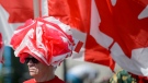 John Weatherbed, wearing a hat made of Canadian flags, takes part in the East York Canada Day Parade in Toronto, on Monday, July 1, 2019. (THE CANADIAN PRESS / Andrew Lahodynskyj)