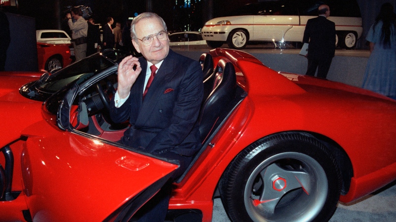 In this March 28, 1990, file photo, Chrysler Corporation Chairman Lee Iacocca sits in a 1990 Dodge Viper sports car as the Chrysler in the 90's six city tour makes a visit to New York. (AP Photo/Osamu Honda, File)