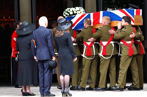 British soldiers carry the coffin of a fellow soldier, slain in Afghanistan, into The Guards Chapel, in the Wellington Barracks in London, on Thursday, July 16, 2009. (AP / Sang Tan)