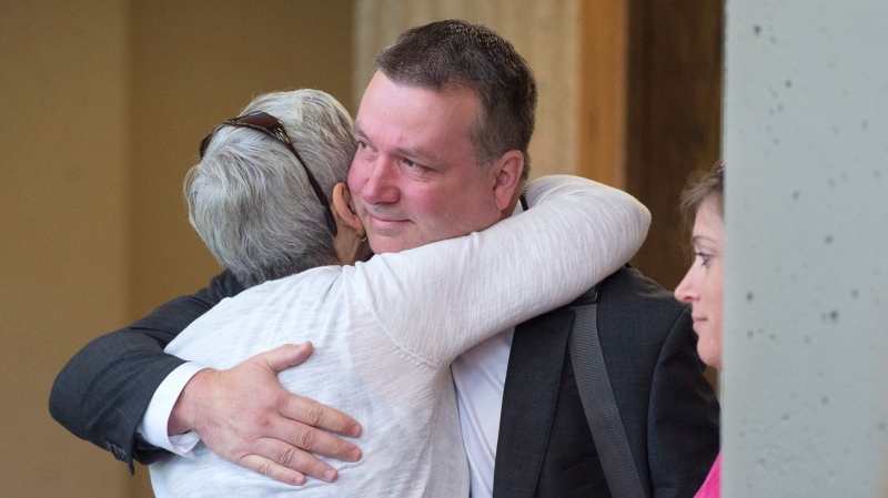 Craig Robert Burnett, a former senior Nova Scotia Mountie convicted of stealing 10 kilograms of cocaine from an exhibit locker, is greeted by family and friends as he arrives for sentencing at Nova Scotia Supreme Court in Halifax on Thursday, July 4, 2019. (THE CANADIAN PRESS/Andrew Vaughan)