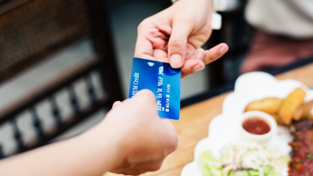 A waitress relieving a credit card is seen in this file image. (Pexels) 