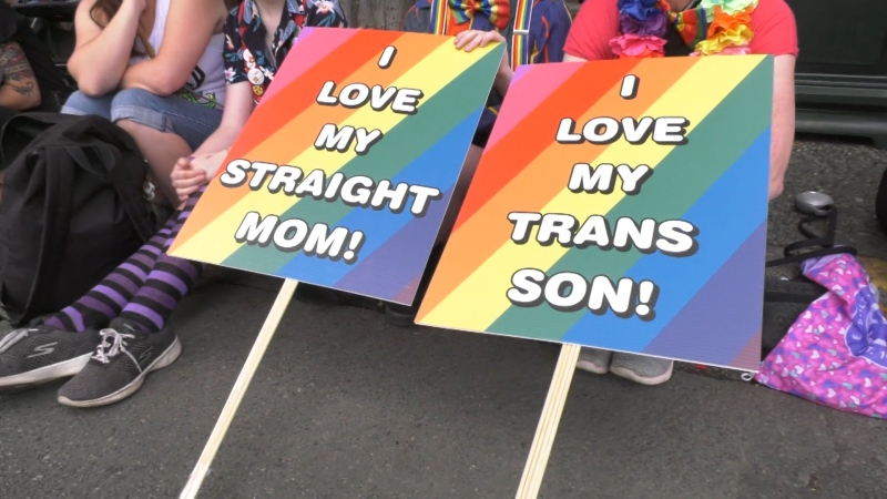 One of the families celebrating pride this year was that of a 13-year-old transgender man named Morgan, whose mother held a sign saying "I love my trans son."