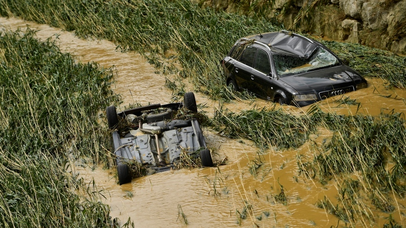Cars are partially submerged after heavy rains in Tafalla, northern Spain, Tuesday, July 9, 2019. (AP Photo/Alvaro Barrientos)