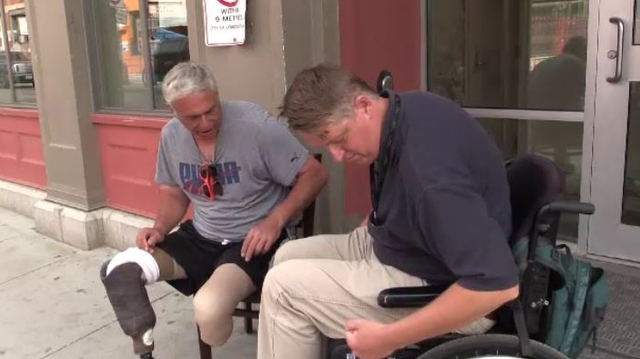Gerry LaHay, left, helps Bruce Dust learn how to get around in his wheelchair in London, Ont. on Tuesday, July 9, 2019. (Gerry Dewan / CTV London)