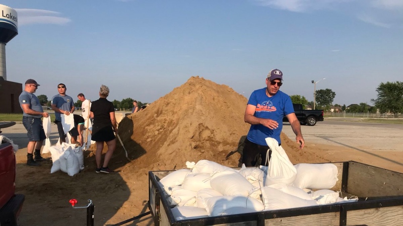 A number of OPP volunteers help residents in Lakeshore fill sandbags on July 10, 2019. ( Alana Hadadean / CTV Windsor )