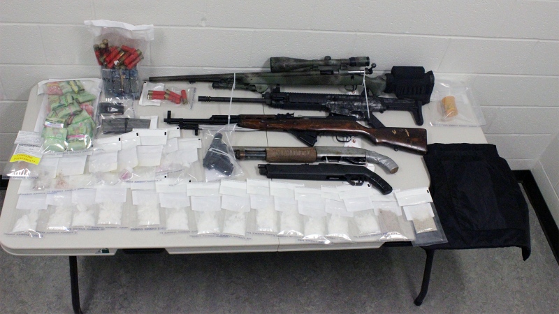 Drugs, guns and ammunition seized by police in Red Deer and Sylvan Lake are displayed. (Supplied)