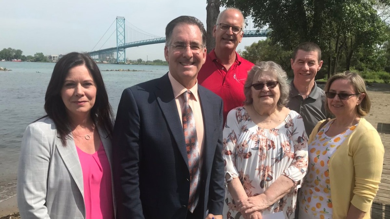 Windsor West MP Brian Masse (middle) is surrounded by MPP Lisa Gretzky and other residents who want a community benefits package for the Ambassador Bridge construction project. ( Angelo Aversa / CTV Windsor )