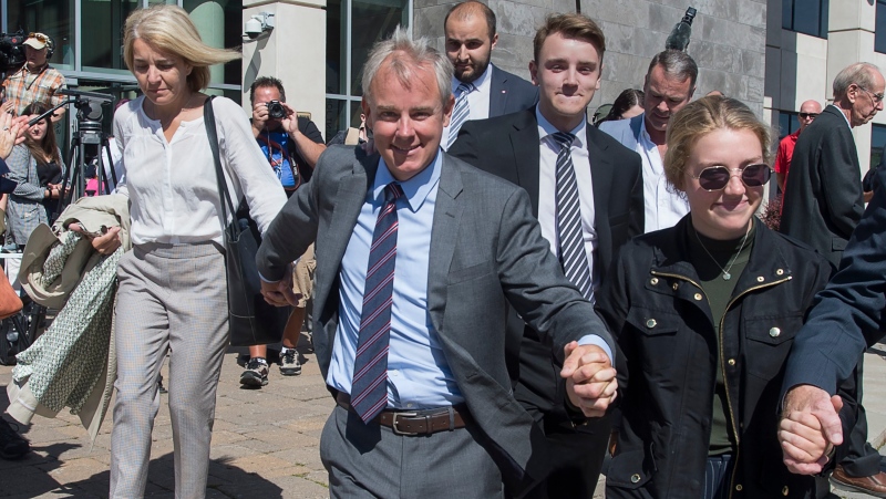 Dennis Oland and family members head from the Law Courts in Saint John, N.B., after he was found not guilty of murdering his father on Friday, July 19, 2019. (THE CANADIAN PRESS/Andrew Vaughan)