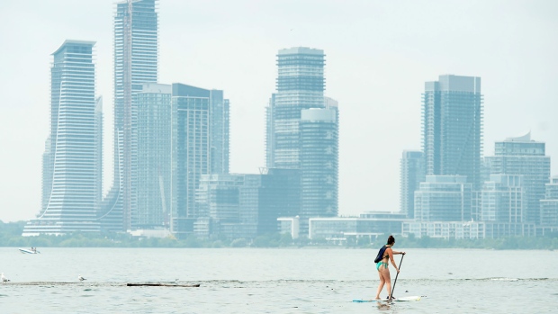 A women paddle boards along Lake Ontario in the extreme heat in Toronto on Friday, July 19, 2019. THE CANADIAN PRESS/Nathan Denette