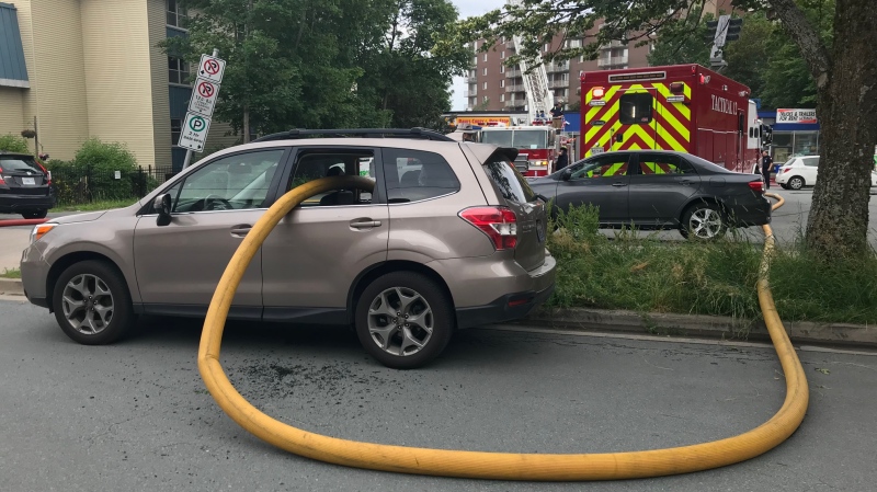 Firefighters smashed the windows of this vehicle and ran their hose right through it in order to access a fire hydrant while battling a blaze in Halifax on July 22, 2019. (CTV / JIM KVAMMEN)