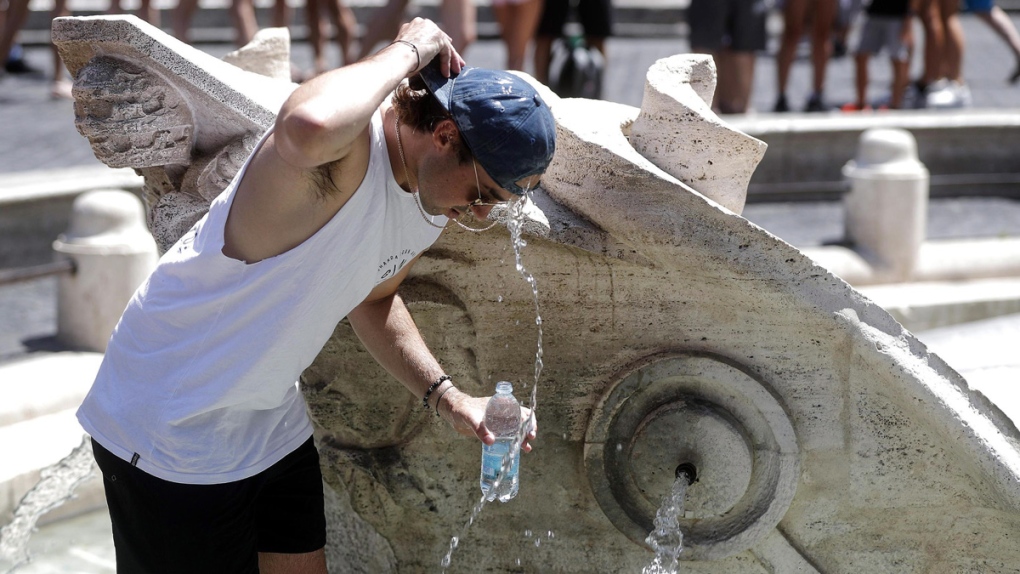A man cools off in a fountain in Rome