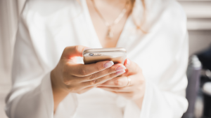 A woman uses a smartphone in an image from shutterstock.com