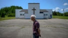 Rod Farrell, a warden at the Church of St. Barra, poses in front of the church closed by the Diocese of Antigonish in Christmas Island, Cape Breton, N.S. on Friday, July 26, 2019. (THE CANADIAN PRESS / Darren Calabrese)