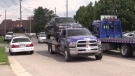 A pickup truck is towed after a police search of a business in east London, Ont. on Monday, July 29, 2019. (Gerry Dewan / CTV London)