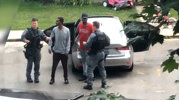 This image taken from viewer video shows the arrest of two men - believed to be suspects in a Sarnia bank robbery - at a townhouse complex in the Jalna Boulevard area of London, Ont on Sunday, July 28, 2019. 
