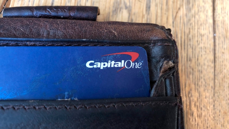 In this Tuesday, July 16, 2019, photo a Capital One credit card is shown in a man's wallet in San Francisco. (AP Photo/Jeff Chiu)