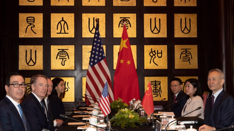 Chinese Vice Premier Liu He, right, sits with U.S. Trade Representative Robert Lighthizer, second from left, and Treasury Secretary Steve Mnuchin, left, before the start of talks at the Xijiao Conference Center in Shanghai Wednesday, July 31, 2019. (AP Photo/Ng Han Guan, Pool)