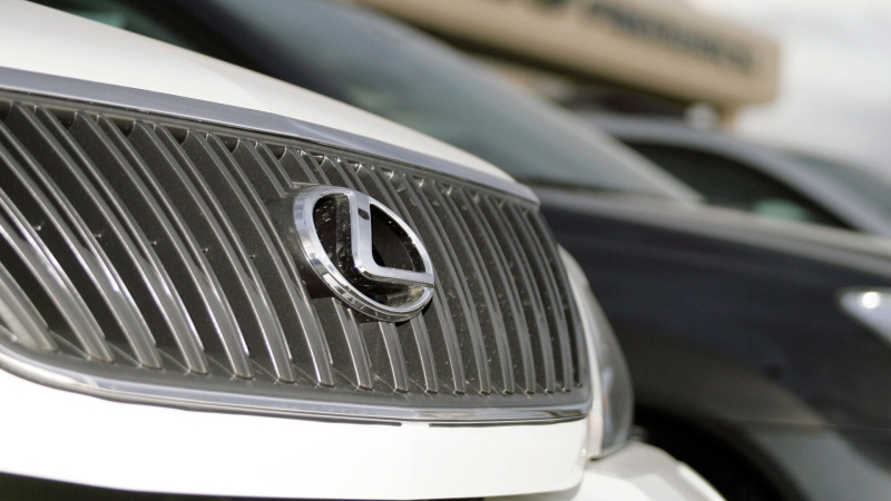 The logo gleams on the chrome grille of an unsold 2007 Lexus RX350 sports utility vehicle parked in front of a Lexus dealership in Frederick, Colo. on Sunday, Oct. 1, 2006. (AP Photo/David Zalubowski) 