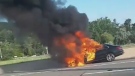 A burning vehicle is pictured following a collision in the westbound express lanes of Highway 401 near Port Union Road Sunday August 4, 2019. (@mandeebaaby /CP24)